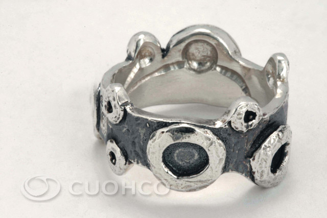 Sterling silver ring of uneven edges with shapes and textures that simulate lunar craters