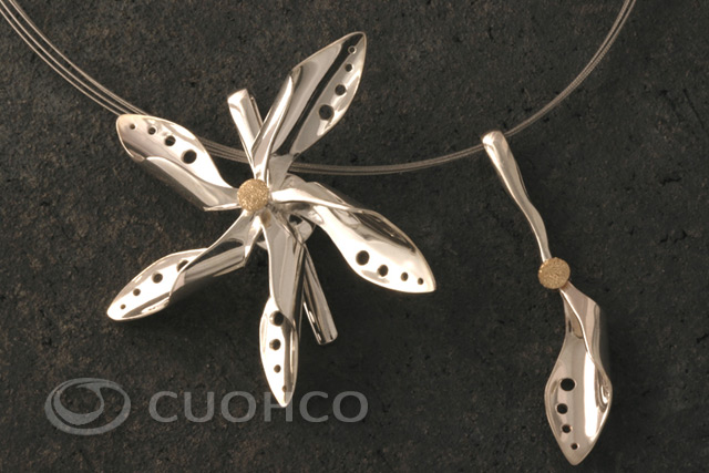 Silver pendant in the shape of a rotary pinwheel with a gold central motif in diamond finish
