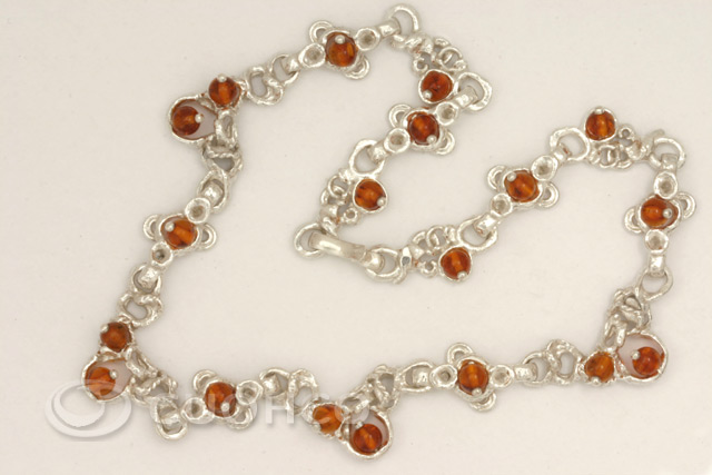 Articulated necklace made of sterling silver and natural amber
