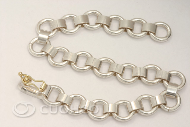 Solid sterling silver bracelet of circular links and hinges with 18-carat gold clasp